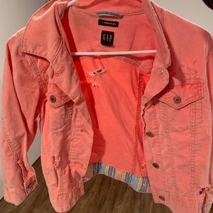 Hot pink cropped denim jacket.